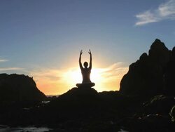 Silhouette of a woman meditating at sunset Stock Footage