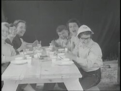 Girl Scouts bang their forks on the picnic table during a camping trip. News Clip