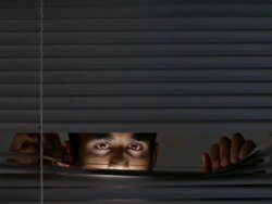 CU Man opening blinds and looking out / Singapore Stock Footage