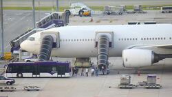 passengers getting off a plane and wait for the bus Stock Footage