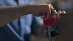 Worker's hand tightens skateboard wheel in skate shop Stock Footage