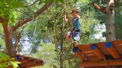 boy in the municipal rope park in summer Stock Footage