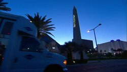 A van drives past the Luxor, a pyramid-shaped casino on the Las Vegas Strip. Stock Footage