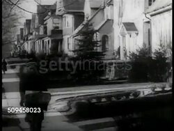 1937: WESTERN UNION: Telegraph delivery boy dressed in heavy WU coat, walking away from doorway, placing paperwork into hat. Instructional Video