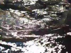 HD Sunlight Reflecting Icy River Close-up Stock Footage