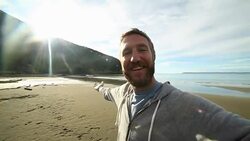 Young man takes selfie portrait on New Zealand's beach Stock Footage