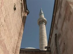 MS View of huge minarett between two sandstone buildings / Konya, Konya, Central turkey, Turkey Stock Footage