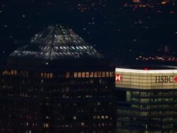 Aerial zoom out from skyscrapers in Canary Wharf at dusk / London Stock Footage