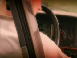 CU track forward along side of car to man starting car ignition, shot through window Stock Footage