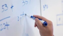 Trendy young businessman's hand writes on conference-room white-board Stock Footage