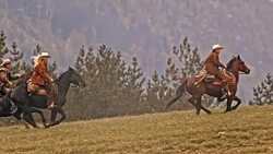 SLO MO TS Two herdsmen and herdswoman riding galloping horses Stock Footage