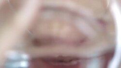 Extreme close-up of young woman with glowing skin drinking a glass of water with camera panning up and down Stock Footage