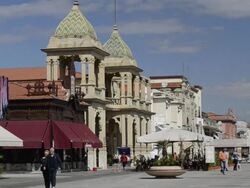 WS View of People walking at beach promenade with Art Nouveau Gran Caffe Margherita / Viareggio, Tuscany, Italy Stock Footage
