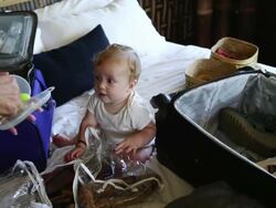 MS Shot of mother and her baby packing up their suitcases / Ubud, Bali, Indonesia Stock Footage