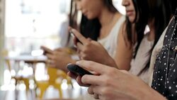 Three young women texting in cafe Stock Footage