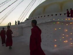 WS TS Young Buddhist monks walking around levels on Boudhanath / Kathmandu, Central, Nepal Stock Footage