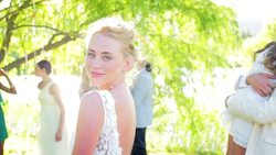Groom hugging and lifting flower girl at wedding reception Stock Footage
