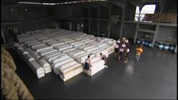 Coffins loaded on navy vessel for transport to disaster area News Clip