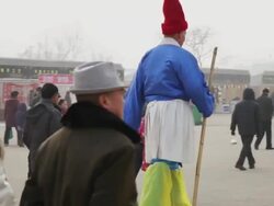 MS TS Chinese folk artists walking along on stilts at temple fair to celebrate Chinese spring festival / xi'an, shaanxi, china Stock Footage