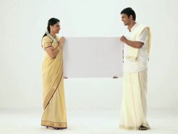 Portrait of a south Indian couple showing a placard  Stock Footage