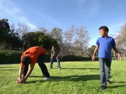 A father teaching his sons how to play American football.  - Slow Motion Stock Footage