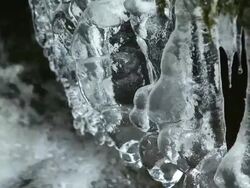 Icicles Hanging Over Pure Creek PAN & TILT Stock Footage