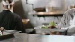Restaurant cook places finished order up on counter in kitchen Stock Footage