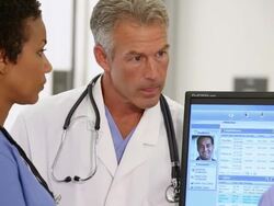 CU PAN Medical Workers Updating and Discussing Patient Records in Hospital / Richmond, Virginia, USA Stock Footage