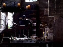 A man in period clothing retrieves a manuscript page from a bookshelf. Stock Footage