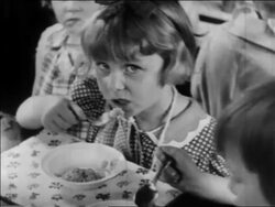 B/W 1934 close up little girl eating in nursery school / WPA project / newsreel Stock Footage