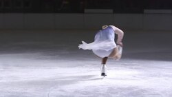 SLO MO Figure skater in performing a sit spin variation Stock Footage