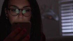 Phone scrutiny, young woman wearing glasses. DS CU Stock Footage