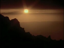 WA Silhouetted mountain range, against hazy light of sunset, Starburst sun in sky, Simian mountains, Ethiopia, African Stock Footage