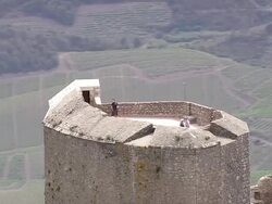 MS AERIAL ZO Shot of people on fort with mountains in Duilhac-sous-Peyrepertuse / Languedoc Roussillon, France Stock Footage