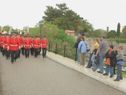 MS PAN Shot of red band walking across bridge in easter parade AUDIO / Kerkyra, Corfu, Greece Stock Footage