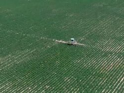 Aerial a tractor spraying crops, Negev, Israel Stock Footage