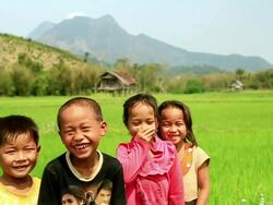 MS SLO MO Shot of four children laughing , rice paddies / Hmong, Luang Prabang, Laos Stock Footage