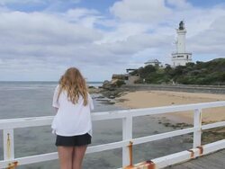 MS Shot of Girl standing in front of lighthouse at great ocean road / Point Lonsdale, Victoria, Australia Stock Footage