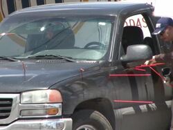 MS View of Mexican CSI looking bullets shots on van door at crime scene AUDIO / Ciudad Juarez, Juarez, Mexico Stock Footage
