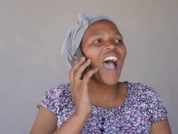 African woman having a good laugh on the phone Stock Footage