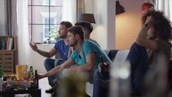 Guys sitting on couch watching tv disappointed Stock Footage