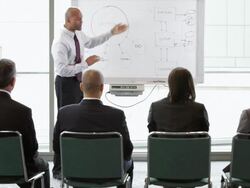  WS Businessman giving a presentation answers a question from colleague who raises hand / Seattle, Washington, United States Stock Footage