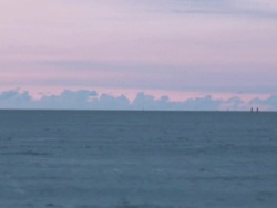 WS People walking in distance on long beach at sunset / St. Peter-Ording, Schleswig Holstein, Germany   Stock Footage
