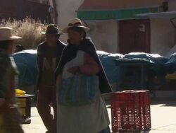 Man walks down street to tricycle/cart stacked with meat, Copacabana, Bolivia Stock Footage