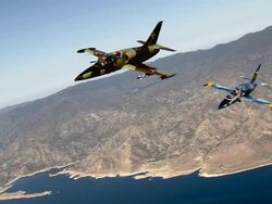 AIR TO AIR, MS, Two Aero L-39 Albatroses flying over Mojave Desert mountains and lake, California, USA Stock Footage