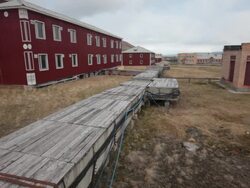 Wooden platforms among beautifully decorated abandoned old houses in Pyramiden, the old abandoned Russian settlement on the archipelago of Svalbard Stock Footage