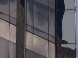 Low Angle static _ Skyscraper windows reflect passing clouds / New York City, New York, USA Stock Footage
