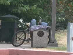 Homeless man sleeps in New Orleans park Stock Footage