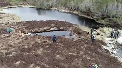 Drone aerial shots of volunteer workers clearing plastic waste News Clip