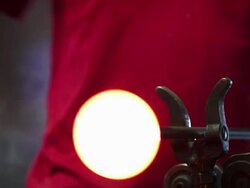 Glass Maker Forming Hot Glass With A Block Closeup Stock Footage